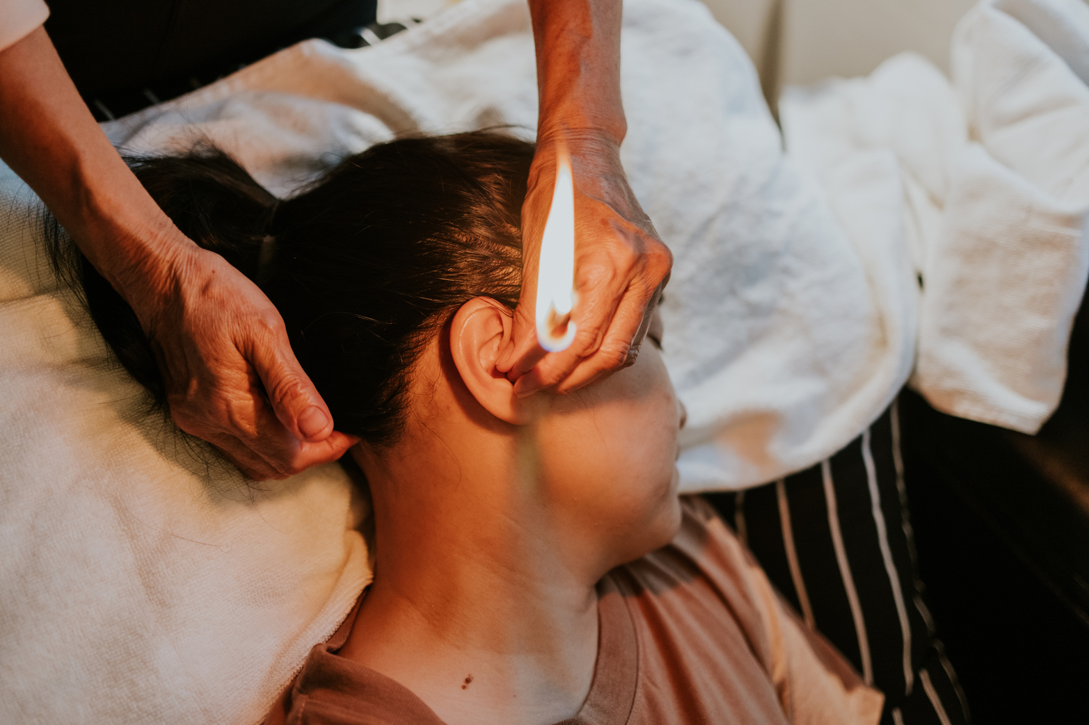 Chinese therapy with ear candling.